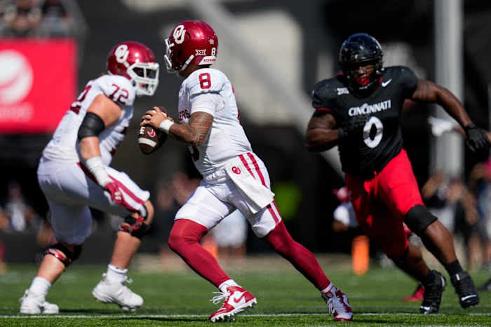 Oklahoma Sooners quarterback Dillon Gabriel (8) scrambles away from Cincinnati Bearcats defensive end Jowon Briggs (0) in the fourth quarter of the NCAA Big 12 football game between the Cincinnati Bearcats and the Oklahoma Sooners at Nippert Stadium in Cincinnati on Saturday, Sept. 23, 2023.